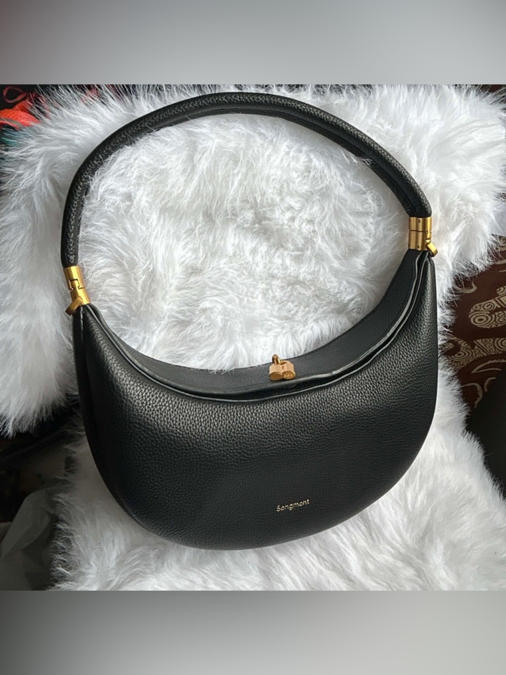 Songmont Black Crescent Shoulder Bag with Gold Accents